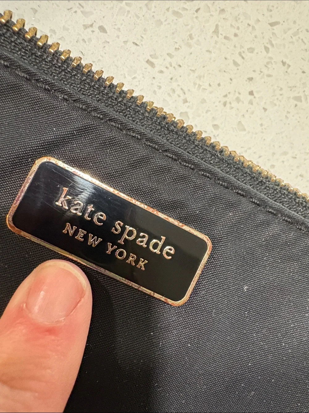 kate spade black crossbody pouch with gold-tone logo
